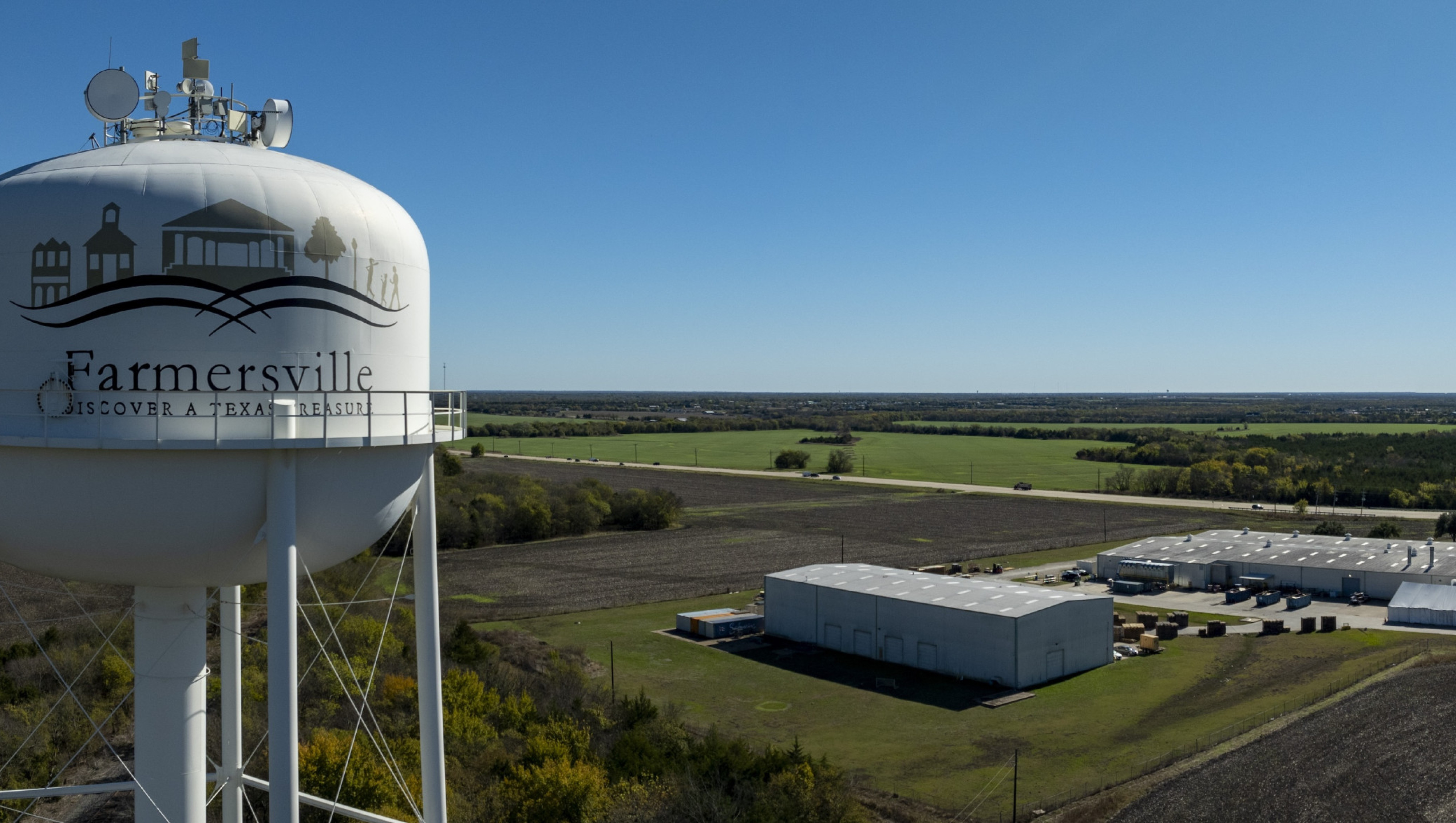 aerial view of farmersville water tower and city in the background